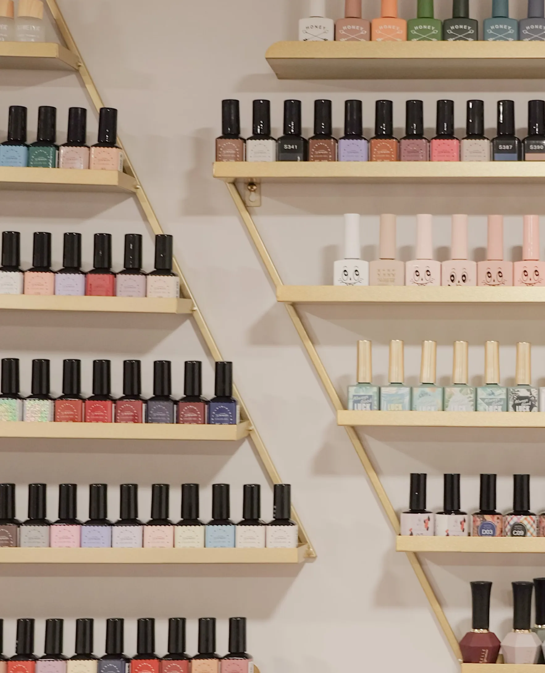 _nail-polish-2 Hands and feet with neatly manicured nails, surrounded by purple flowers and spa items on a wooden surface.